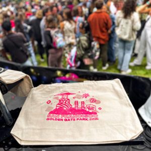 A colorful, screen printed tote featuring bold, bright colors and unique design, a standout souvenir from Outside Lands 2023