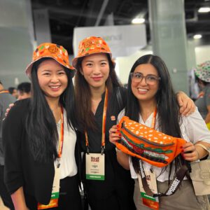 Attendees proudly showcasing their personalized bucket hats and fanny packs