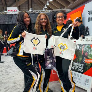 attendees proudly displaying their newly customized 'HBCU Love' tote bag from Home Depot