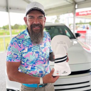 Golfer at the Houston Open holding a laser-engraved club cover, showcasing Lexus’ partnership and our customization.